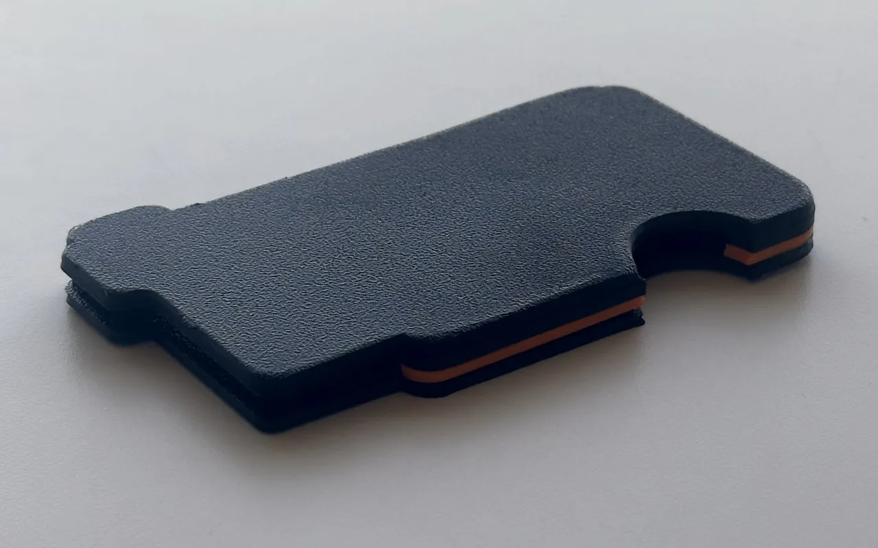 Prototype 1 from the back, with the orange layers showing at the edge.
