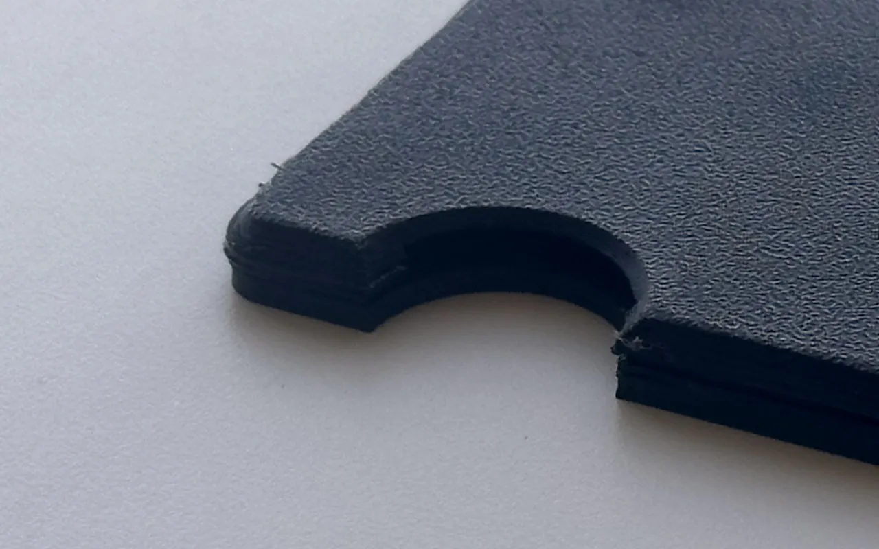 Close-up of prototype 2 at the thumb cutout, showing the layers.